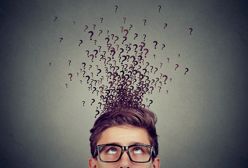 Man with question marks above head