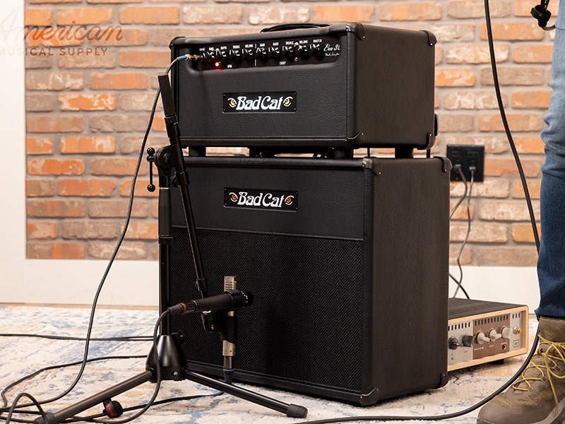Bad Cat Era 30 guitar amplifier head in black with multiple control knobs, stacked on a matching Bad Cat speaker cabinet