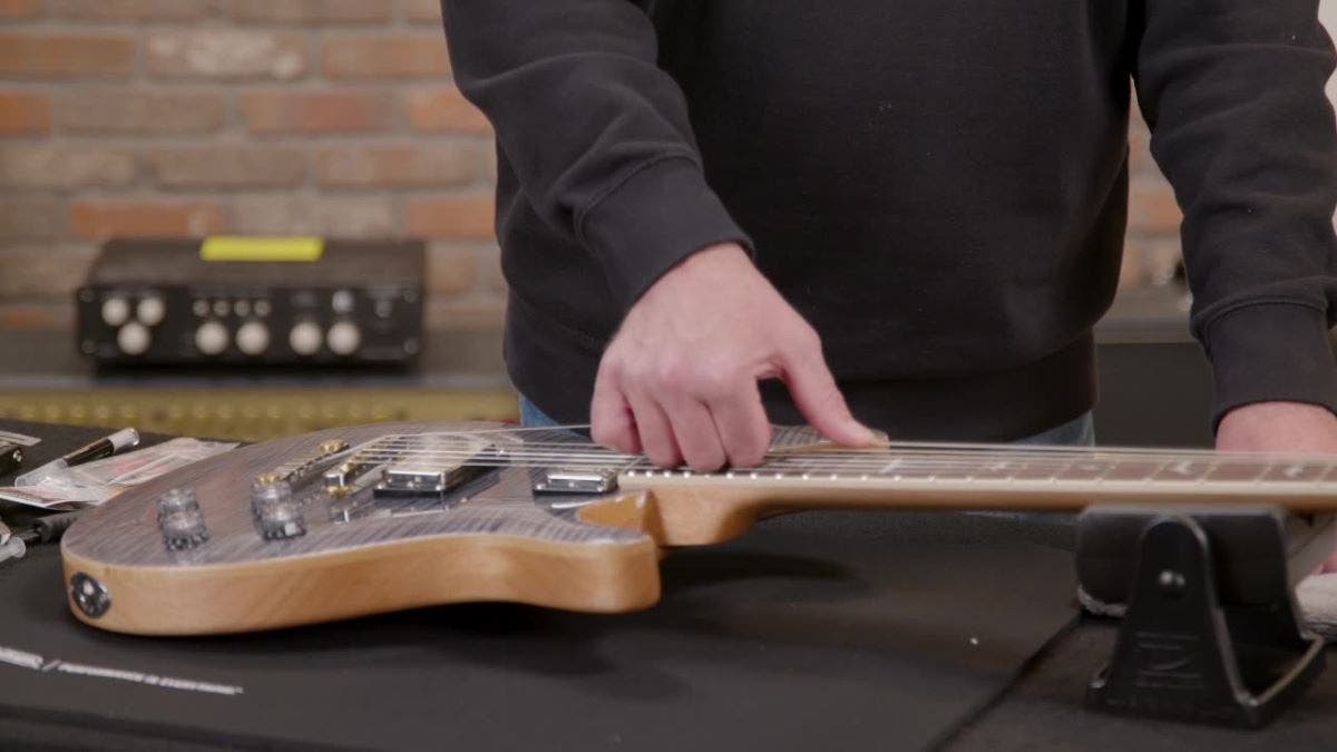 Guitar unboxing tips stretching the strings on a new guitar when tuning AMS
