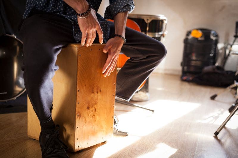 Use a cajon to expand your drum set