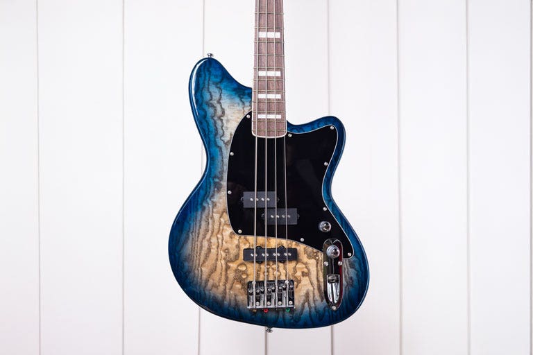 An Ibanez Talman TMB400 bass guitar hanging on a wall