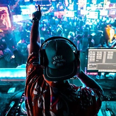 A DJ performing in front of a crowd of people