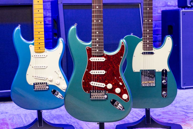 Photo of three solid body electric guitars in the AMS studio