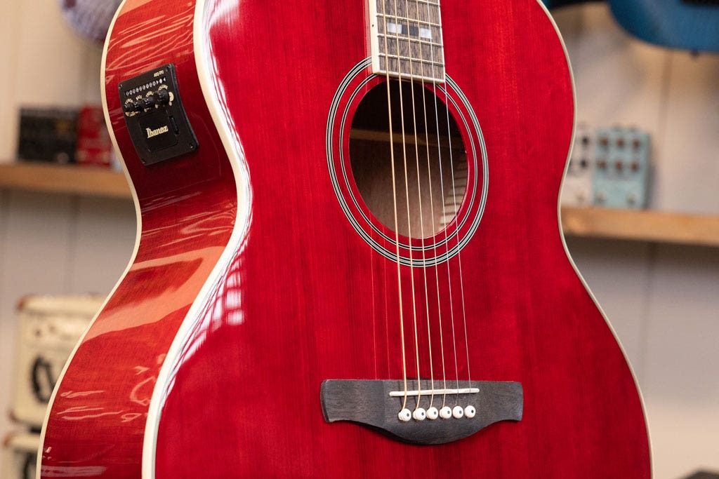 Closeup photo of a red Ibanez acoustic guitar