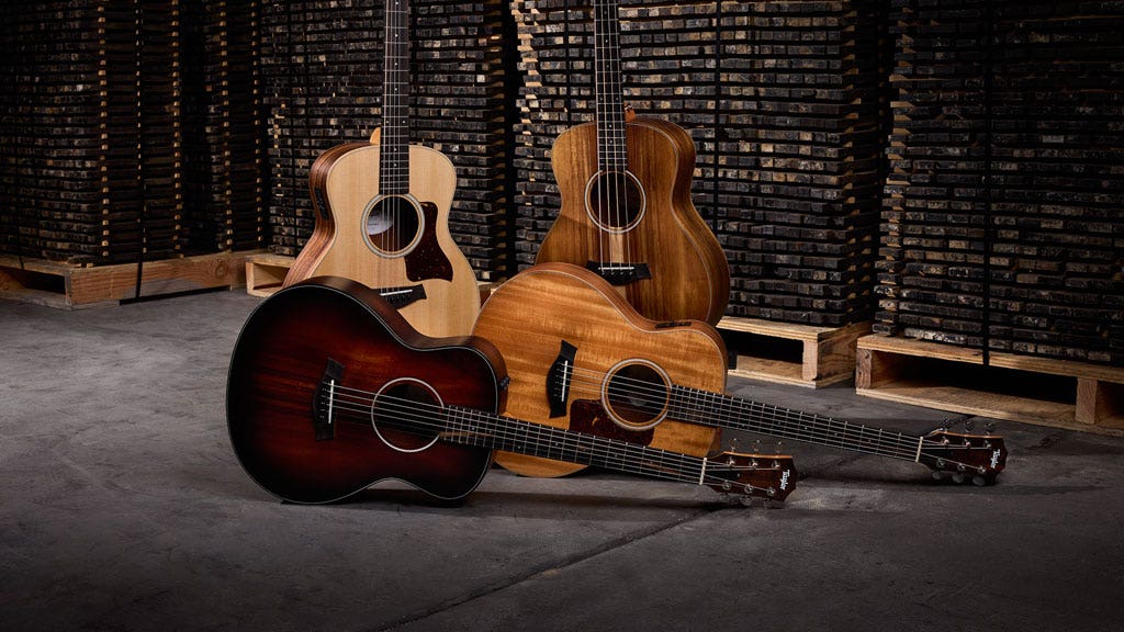 Photo of an assortment of travel-sized acoustic guitars
