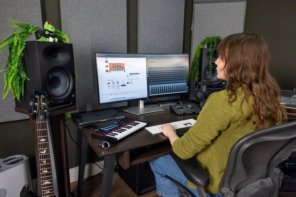 Person sitting at a desk in a recording studio