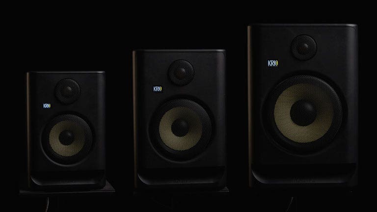 Three KRK studio monitors side by side