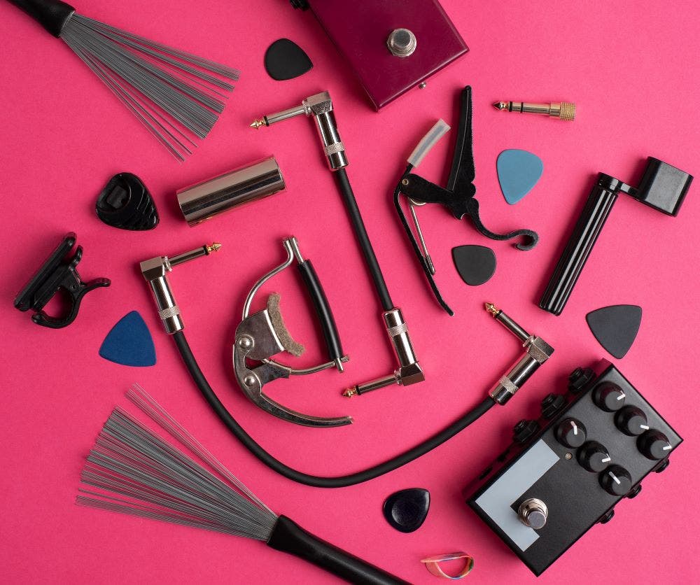 guitar accessories on a pink background