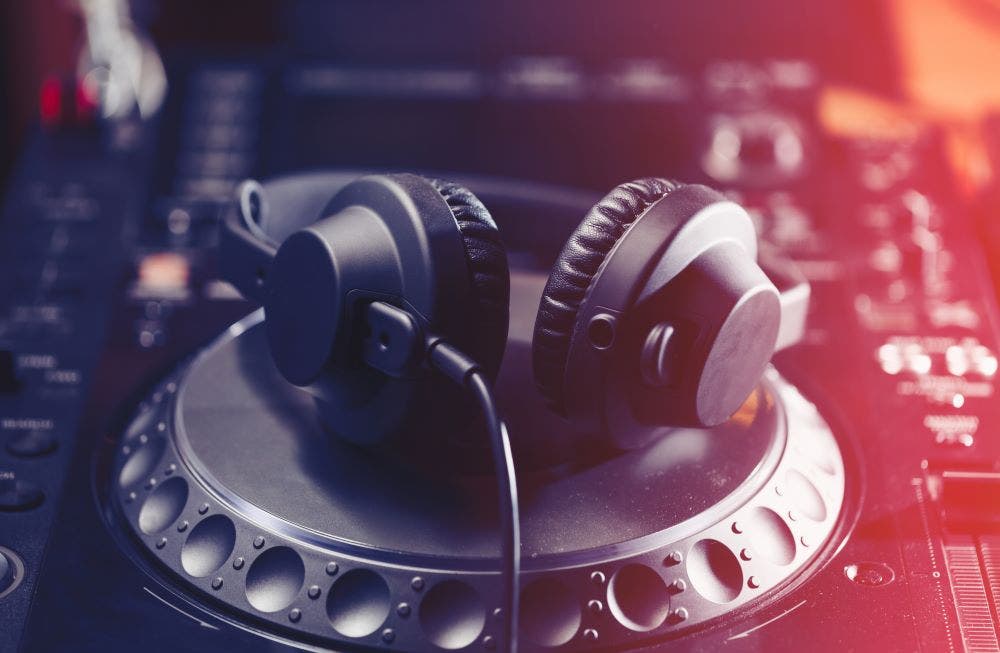 DJ headphones sitting on a controller