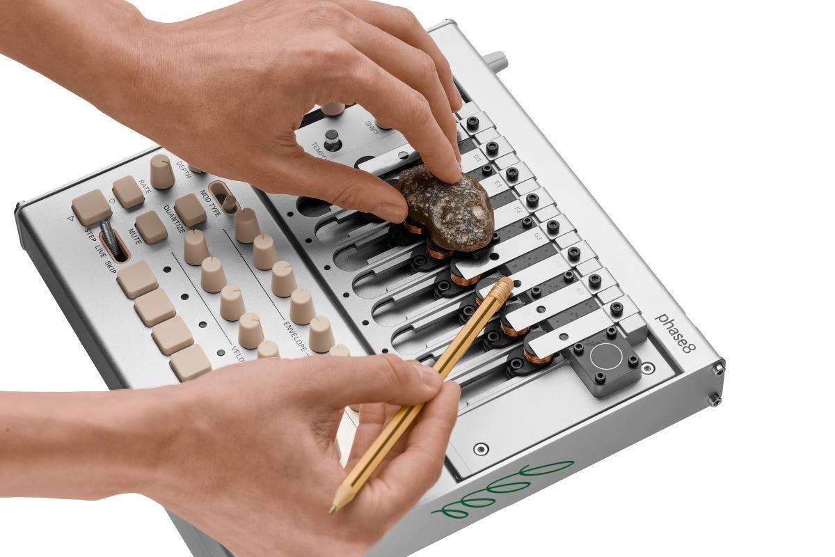 KORG phase8 acoustic synthesizer being played with a rock and pencil American Musical Supply