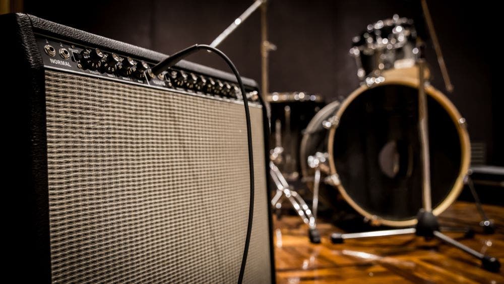 Combo amp in front of a drum set