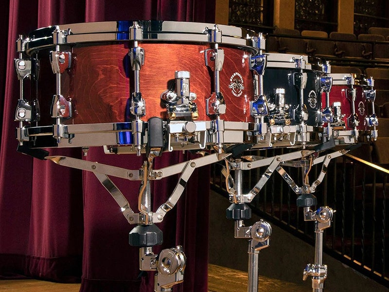 Three snare drums on stands.