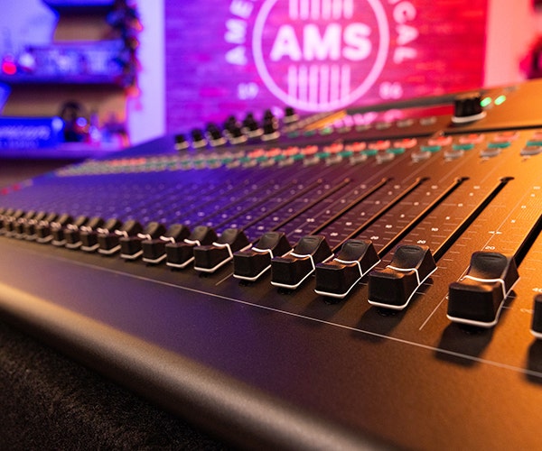 Peavey XR audio mixer with multiple channels, knobs, sliders, and digital display.